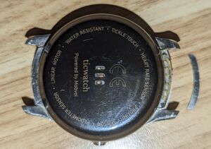 Ticwatch 2 with model number sticker removed, exposing pads